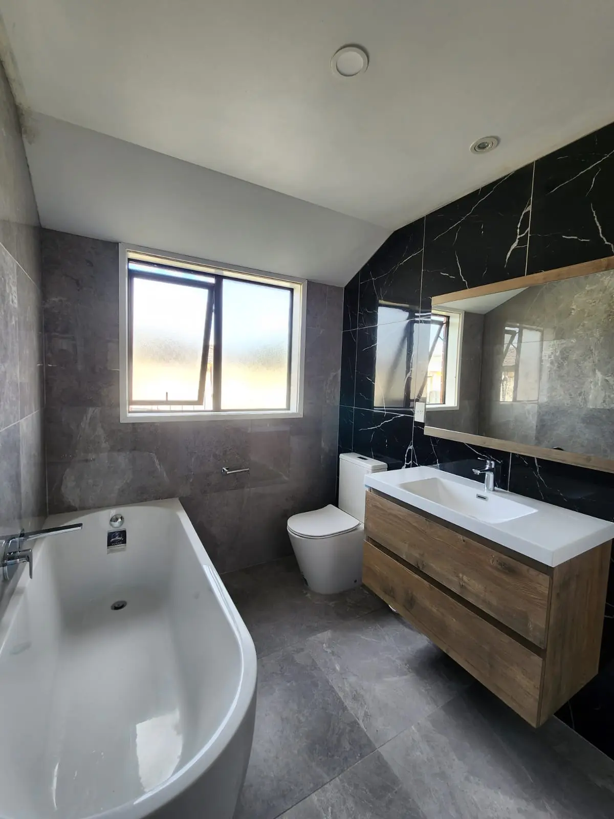 Luxury bathroom featuring freestanding bathtub and natural lighting