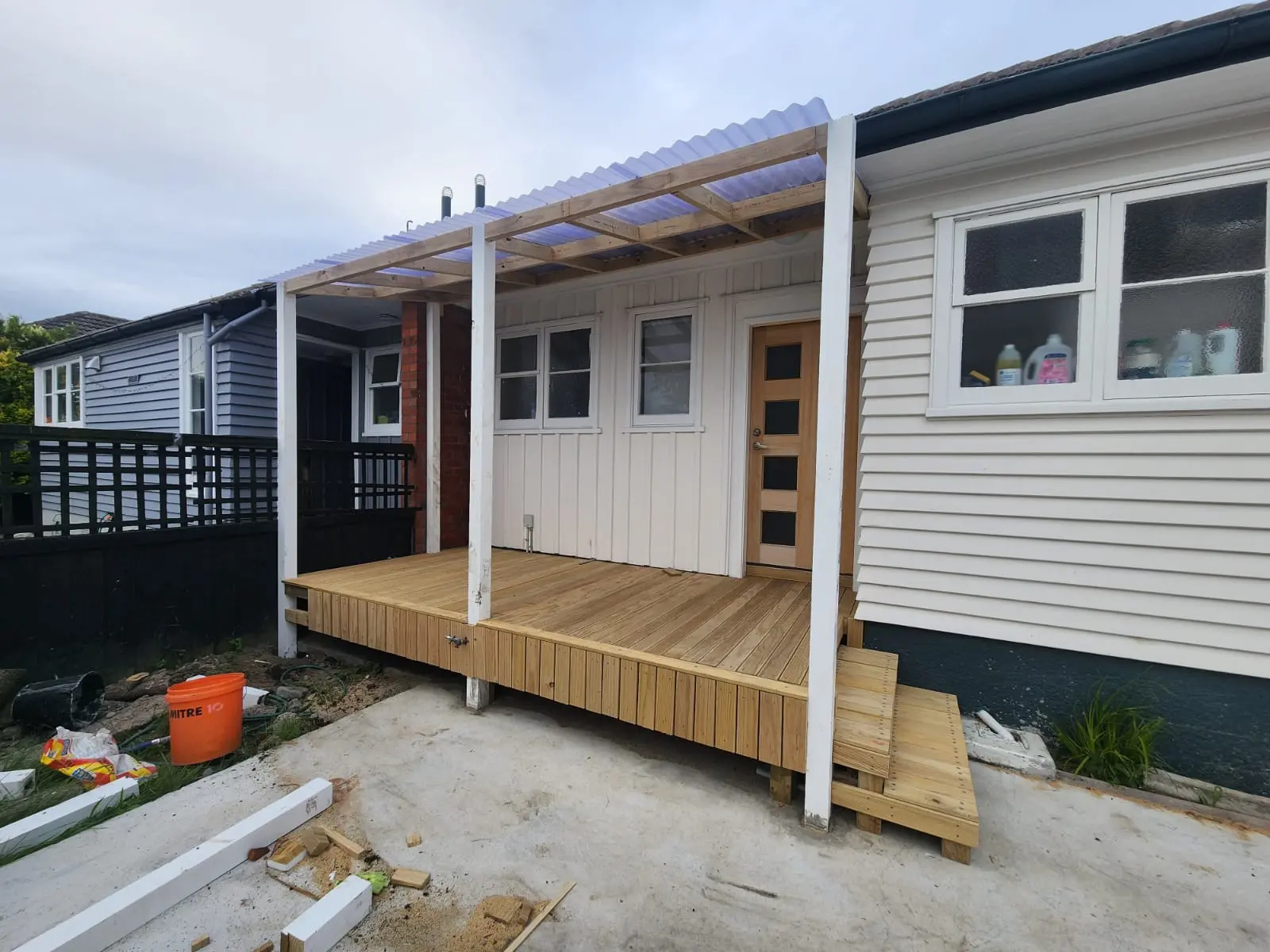 Backyard renovation featuring pergola and outdoor dining setup